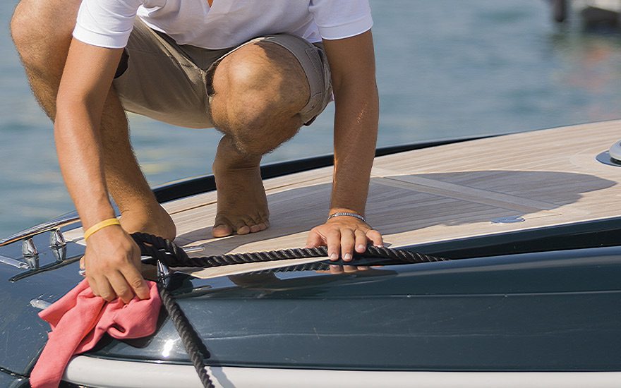 man cleaning top of boat